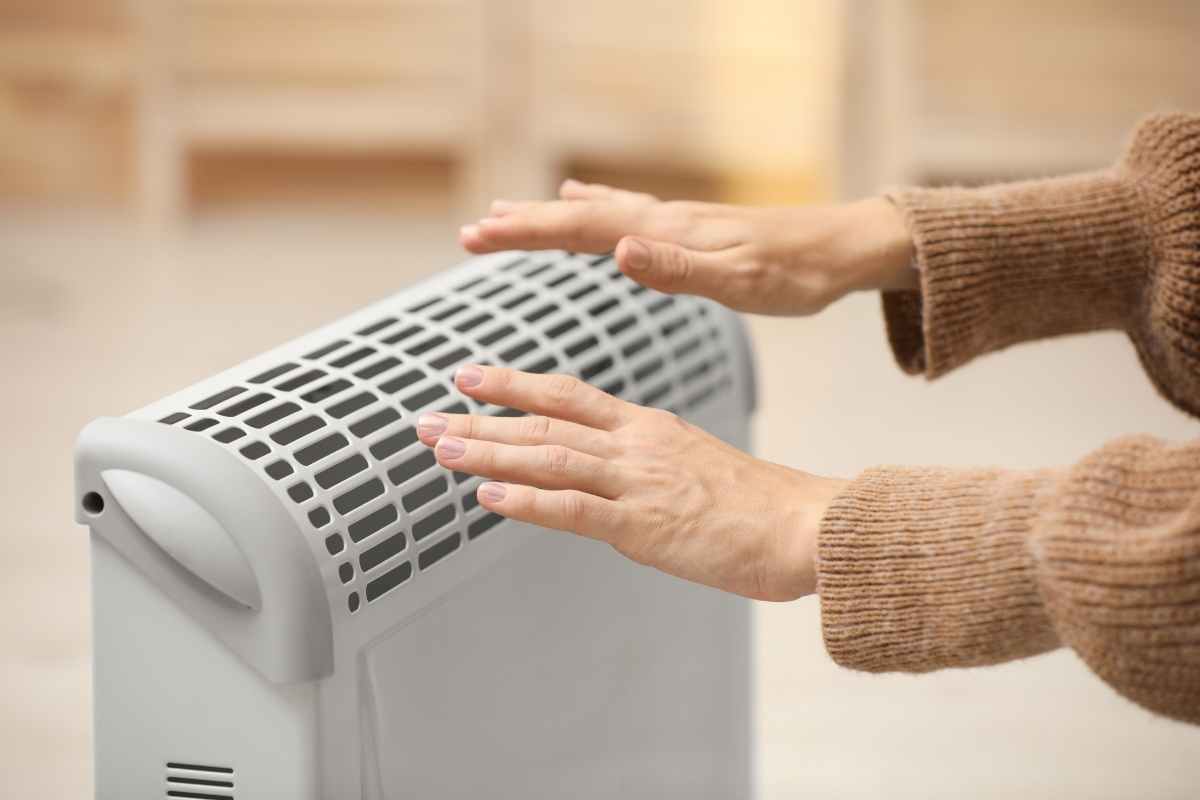 El calor para el invierno, manos en estufa